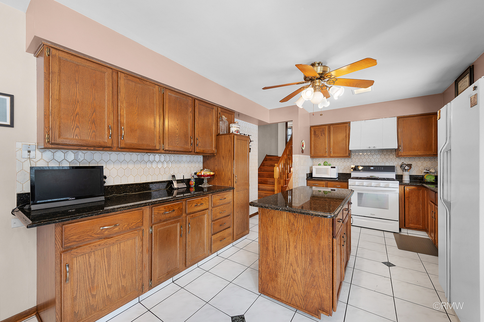 1306 West Byron Avenue Addison, IL 60101 - Photo 20 of 25 a kitchen with granite countertop a sink counter top space appliances and cabinets