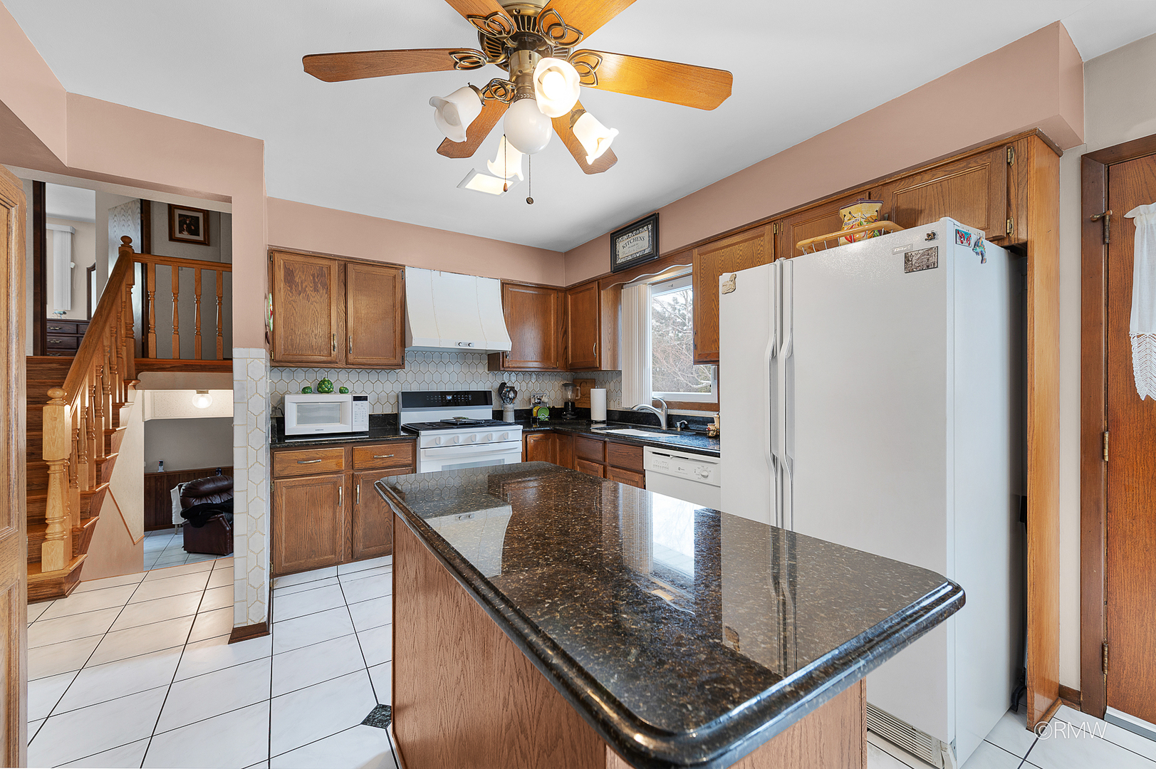 1306 West Byron Avenue Addison, IL 60101 - Photo 21 of 25 a kitchen with stainless steel appliances granite countertop a refrigerator a stove and a sink with cabinets