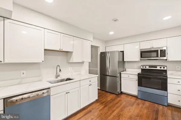 a kitchen with stainless steel appliances a refrigerator sink and microwave
