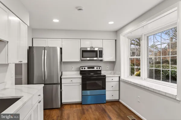a kitchen with stainless steel appliances a refrigerator and a stove top oven