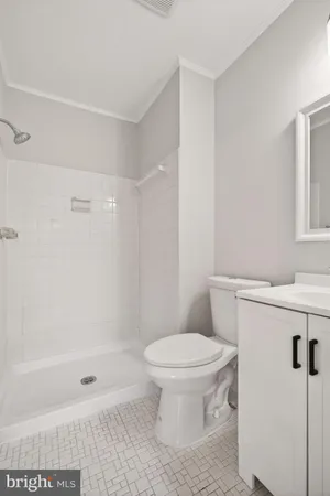 a bathroom with a toilet and a shower
