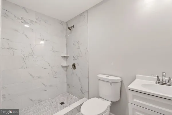 a white toilet sitting next to a bathroom sink