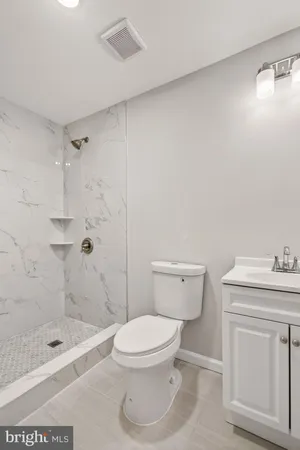 a bathroom with a toilet a sink and shower
