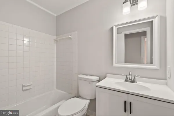 a bathroom with a sink toilet vanity and shower