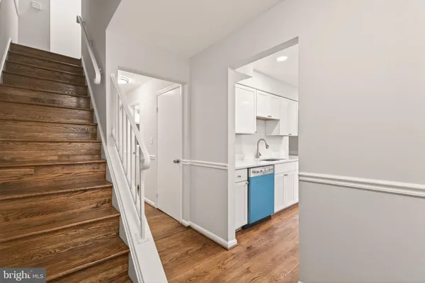 a view of a kitchen with sink and wooden floor