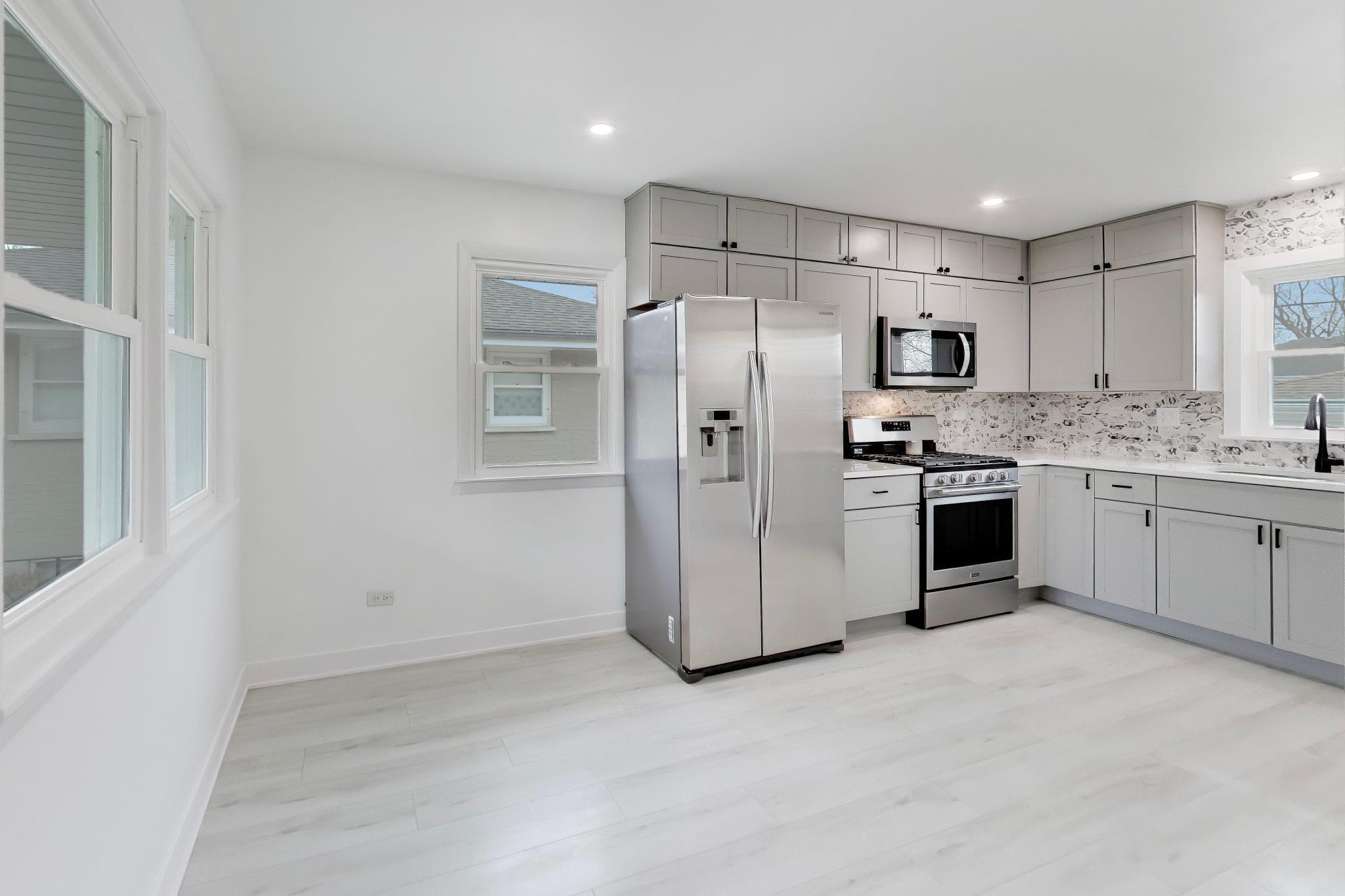 2022 38th Street Highland, IN 46322 - Photo 13 of 41 a kitchen with stainless steel appliances a refrigerator sink and cabinets