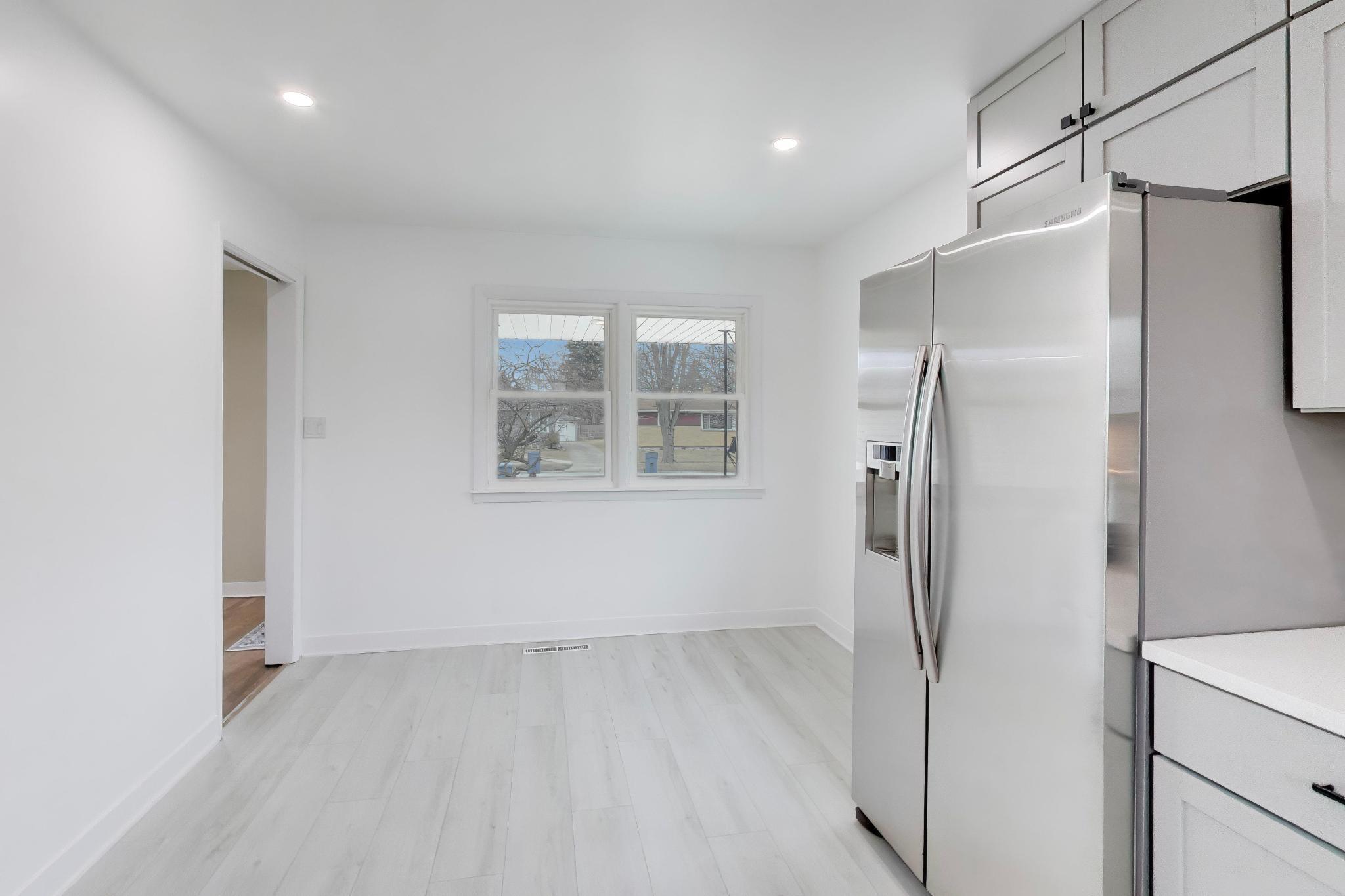 2022 38th Street Highland, IN 46322 - Photo 15 of 41 a view of a refrigerator in kitchen and wooden floor