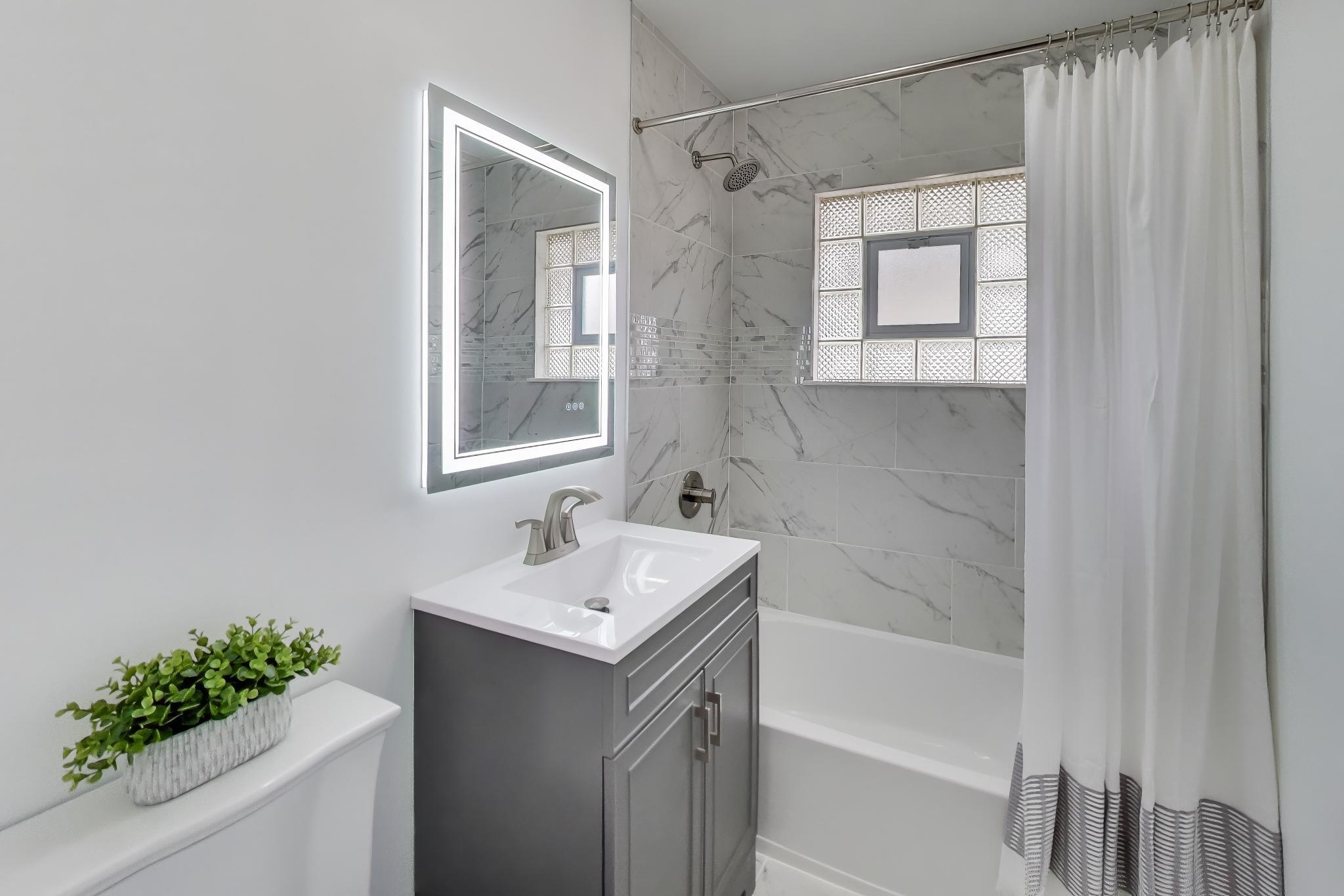 2022 38th Street Highland, IN 46322 - Photo 16 of 41 a bathroom with a sink toilet and shower
