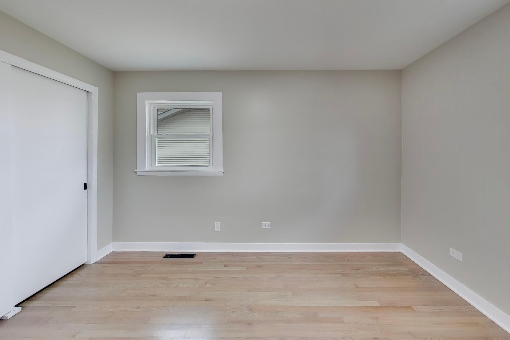 2022 38th Street Highland, IN 46322 - Photo 18 of 41 a view of an empty room with wooden floor and a window