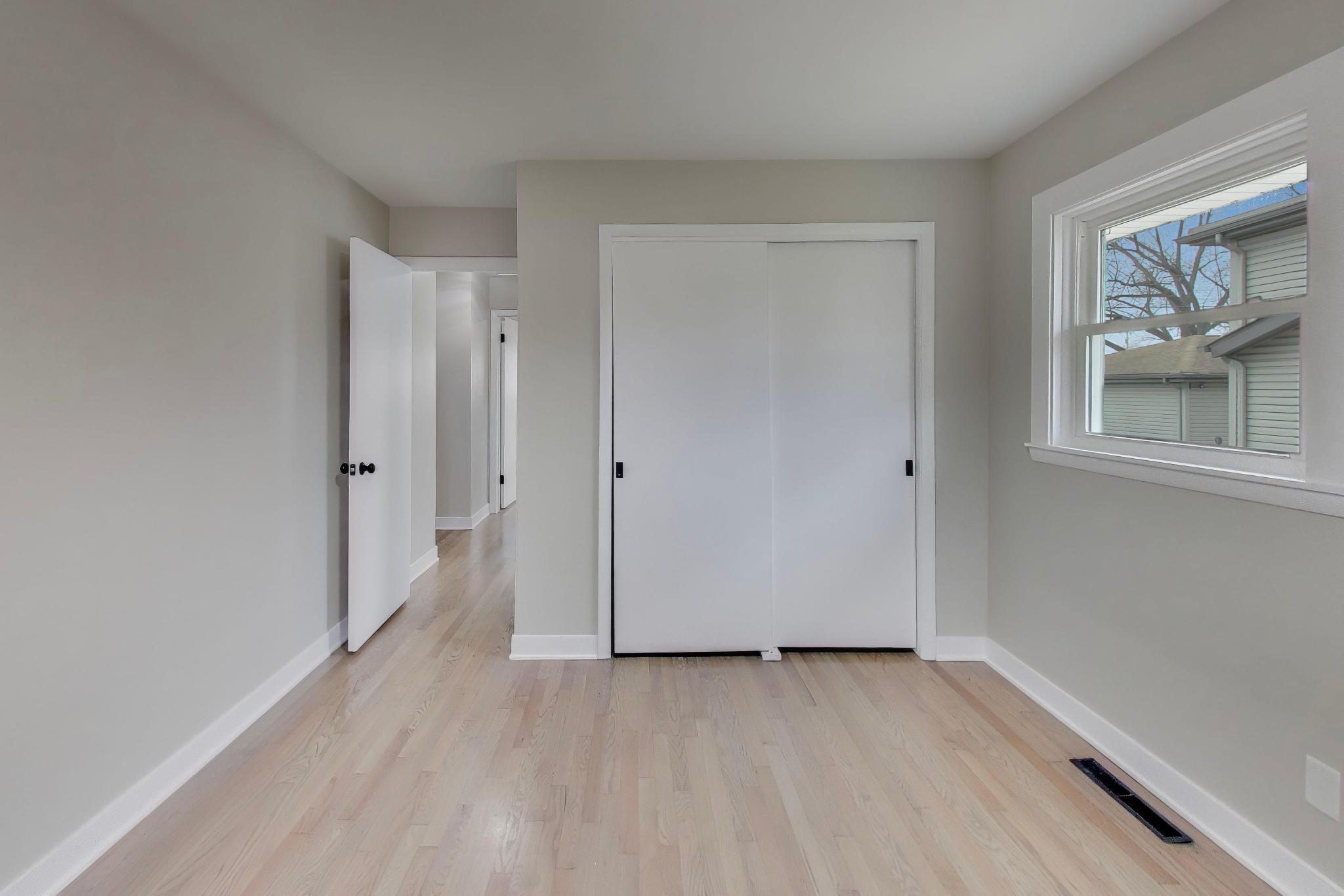 2022 38th Street Highland, IN 46322 - Photo 19 of 41 an empty room with wooden floor and window