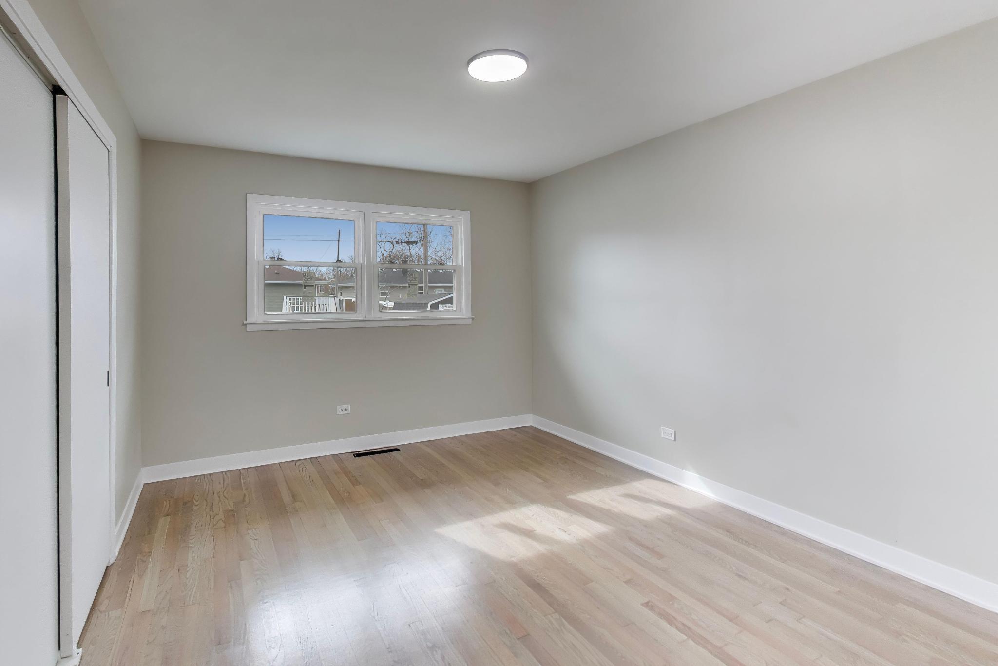 2022 38th Street Highland, IN 46322 - Photo 21 of 41 an empty room with wooden floor and windows