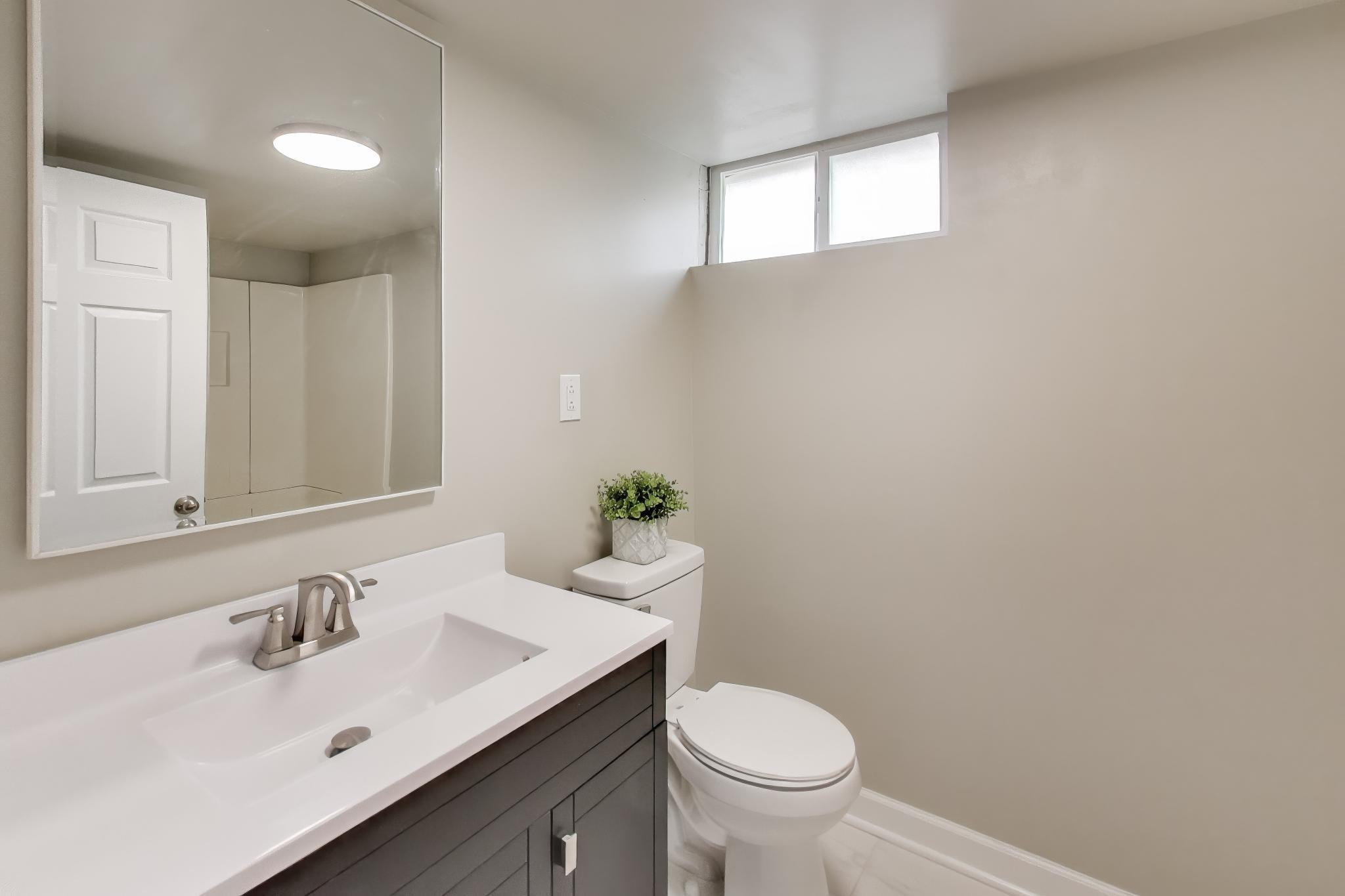 2022 38th Street Highland, IN 46322 - Photo 26 of 41 a bathroom with a sink and a toilet