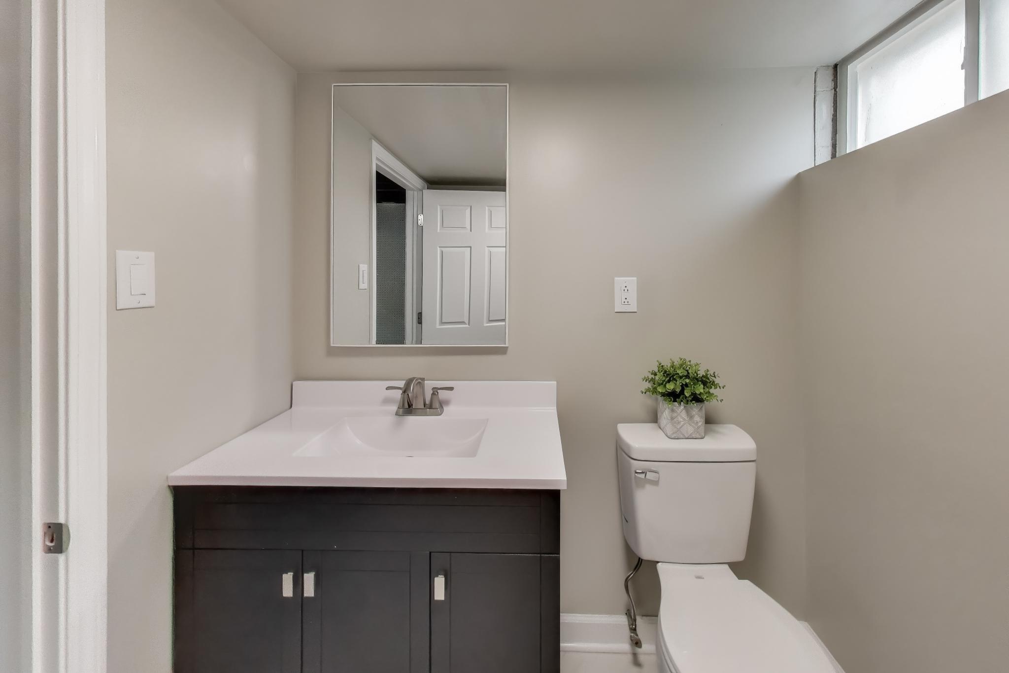 2022 38th Street Highland, IN 46322 - Photo 27 of 41 a bathroom with a toilet sink and mirror
