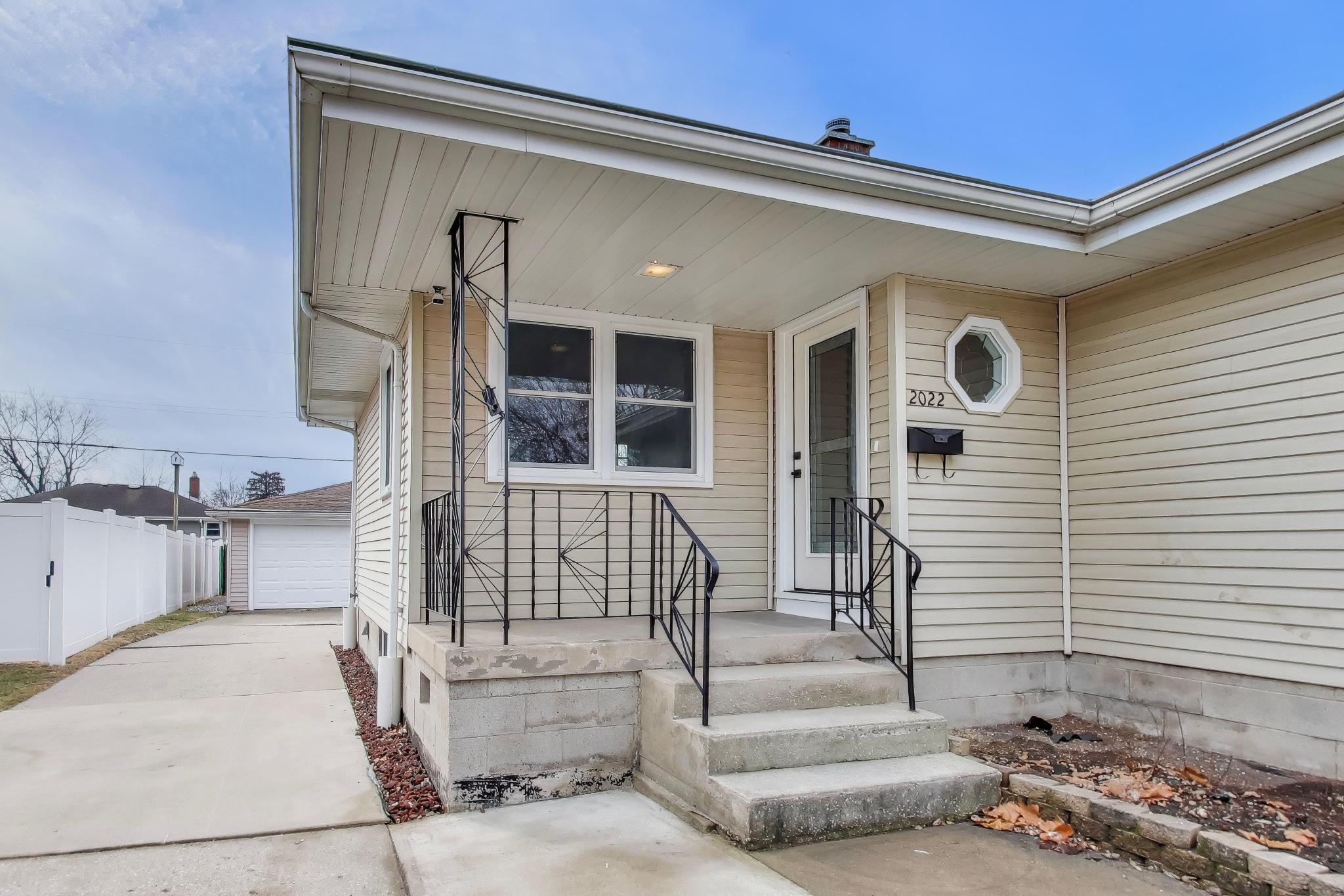 2022 38th Street Highland, IN 46322 - Photo 5 of 41 a view of a porch with a table and chairs