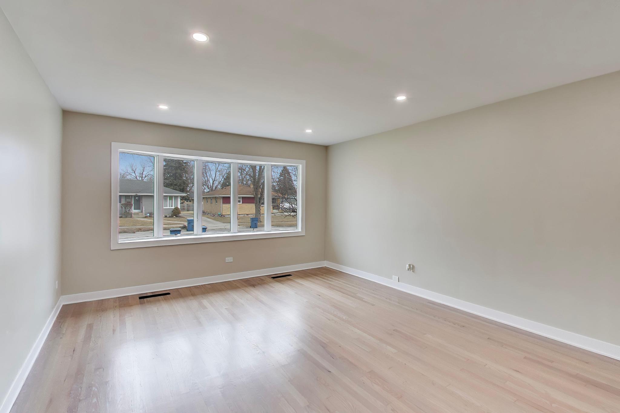 2022 38th Street Highland, IN 46322 - Photo 7 of 41 a view of an empty room with wooden floor and a window