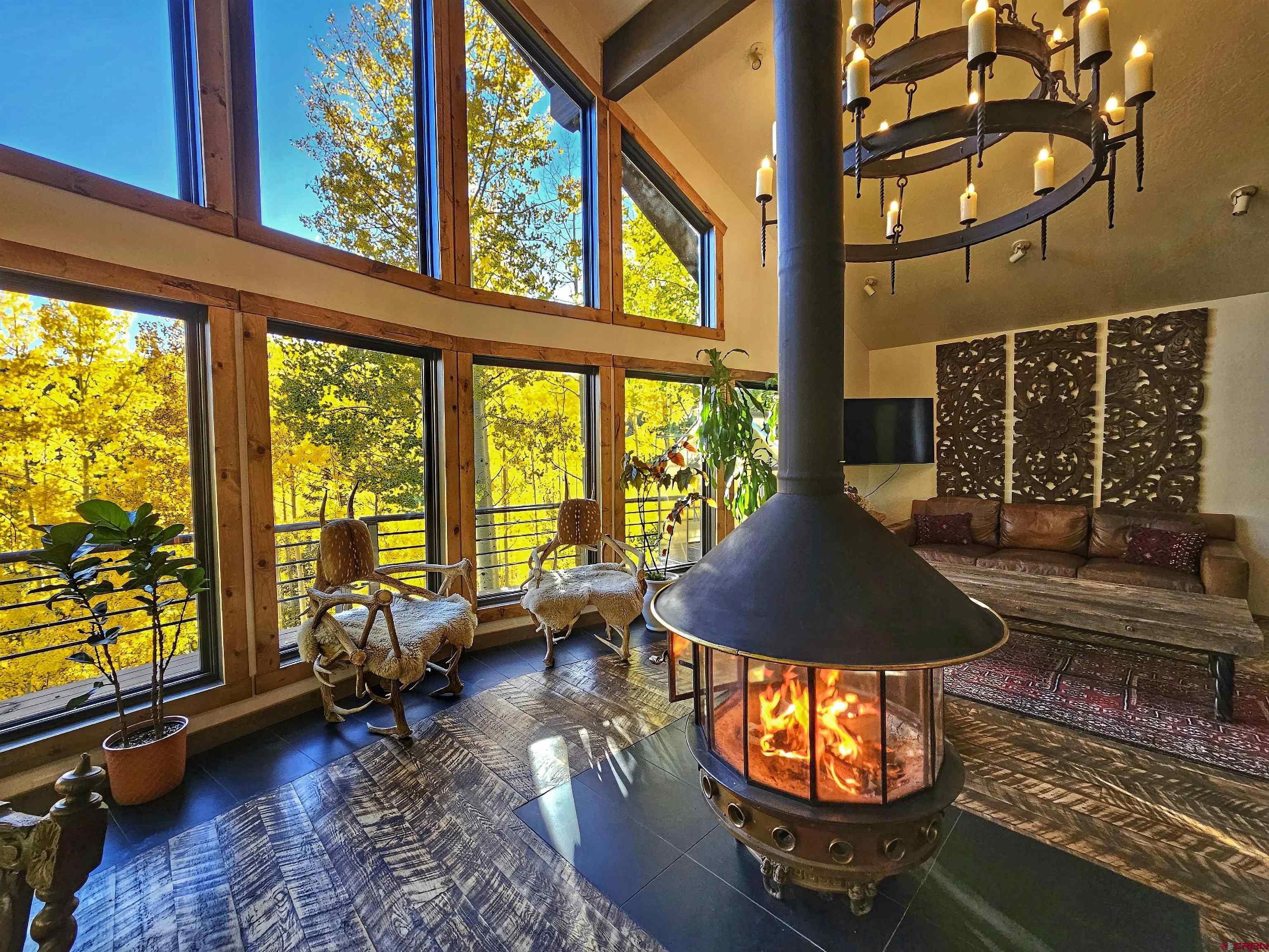 214 East Mill Road Rico, CO 81332 - Photo 3 of 45 a living room with furniture and floor to ceiling windows