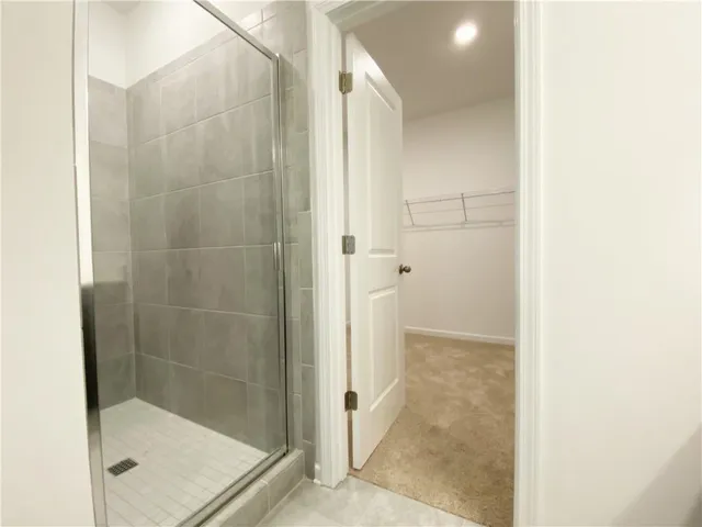 a bathroom with a double vanity sink a toilet and shower