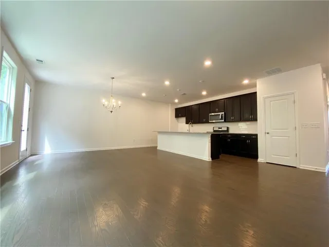 a view of kitchen with kitchen island and stainless steel appliances