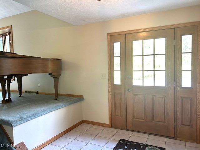 3422 Southern Road Richfield, OH 44286 - Photo 20 of 42 Foyer entrance with light tile patterned flooring and a textured ceiling