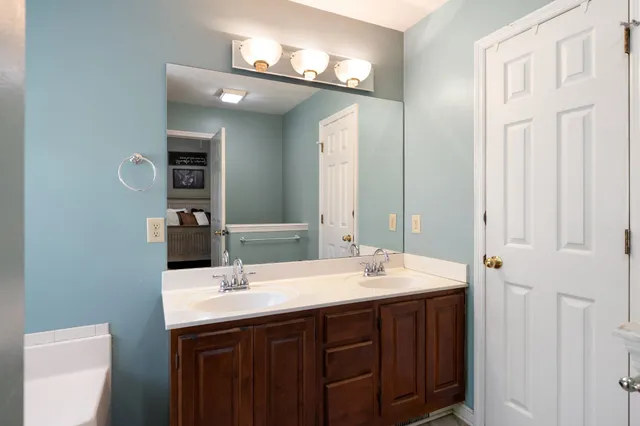a bathroom with a double vanity sink and a mirror