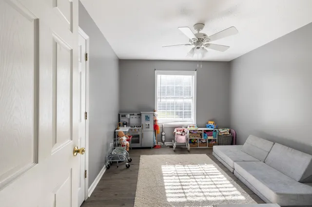 a view of a livingroom with furniture and a window