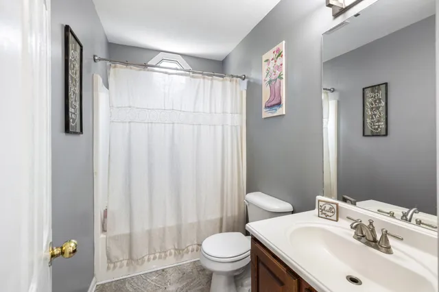 a bathroom with a sink toilet and a mirror