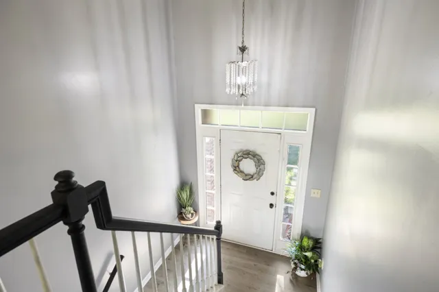 a view of a hallway with entryway wooden floor and front door