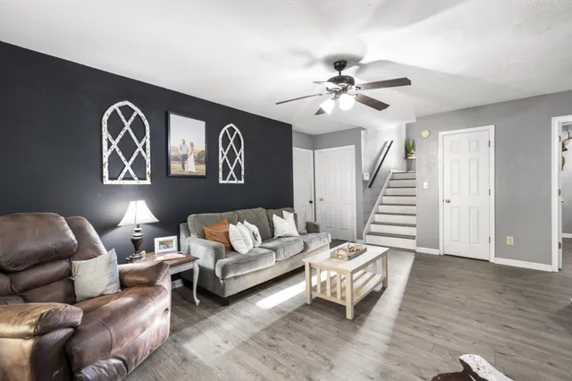 a living room with furniture and wooden floor
