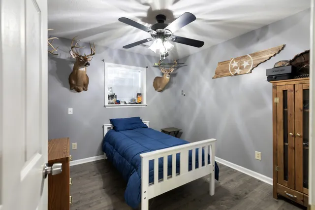 a bedroom with a bed and a chandelier