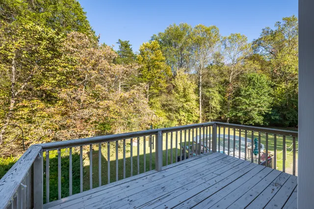 a view of balcony with wooden floor and fence