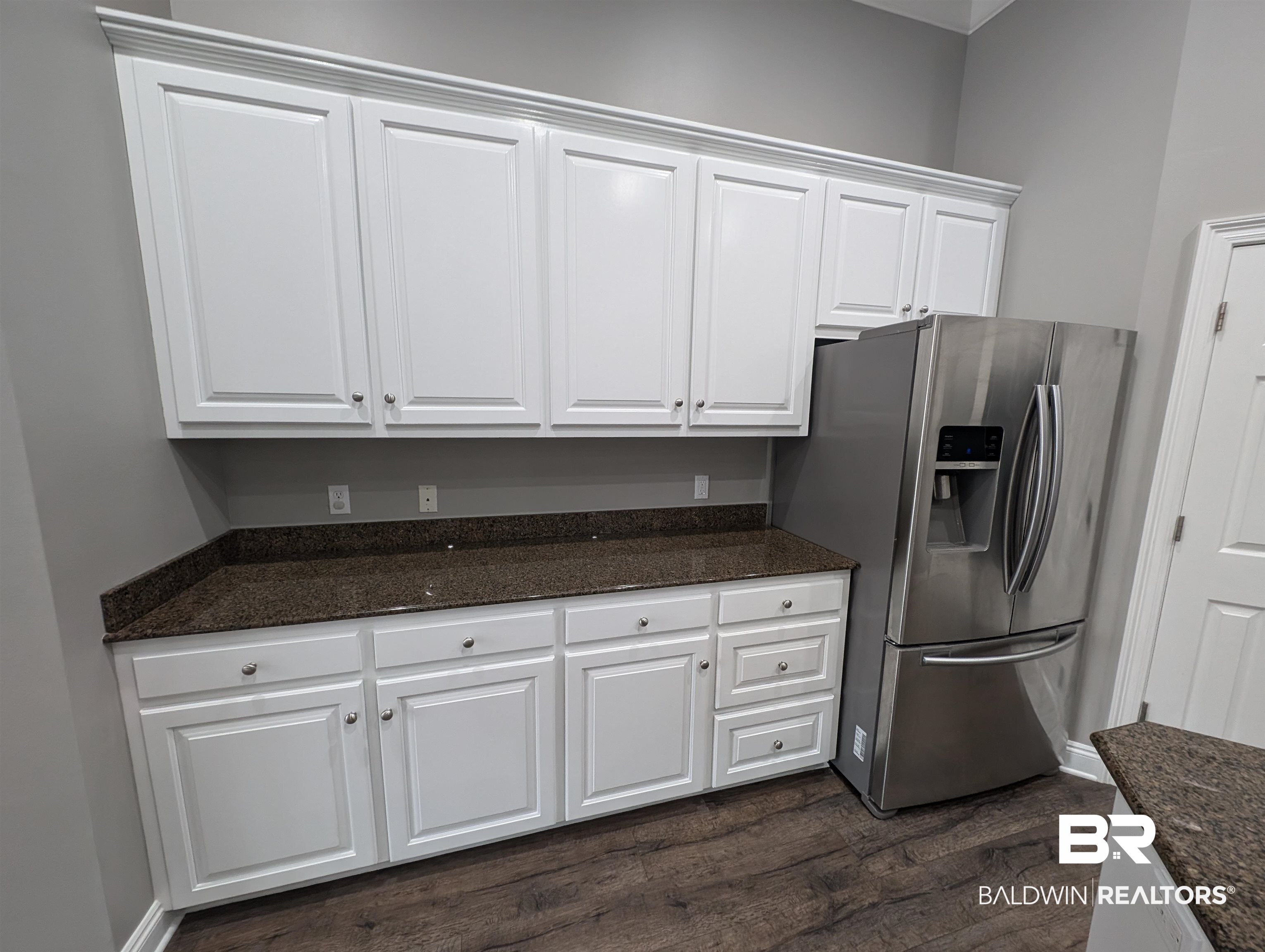 11623 Halcyon Loop Daphne, AL 36526 - Photo 33 of 90 Kitchen featuring dark stone counters, dark wood-type flooring, stainless steel fridge with ice dispenser, and white cabinets