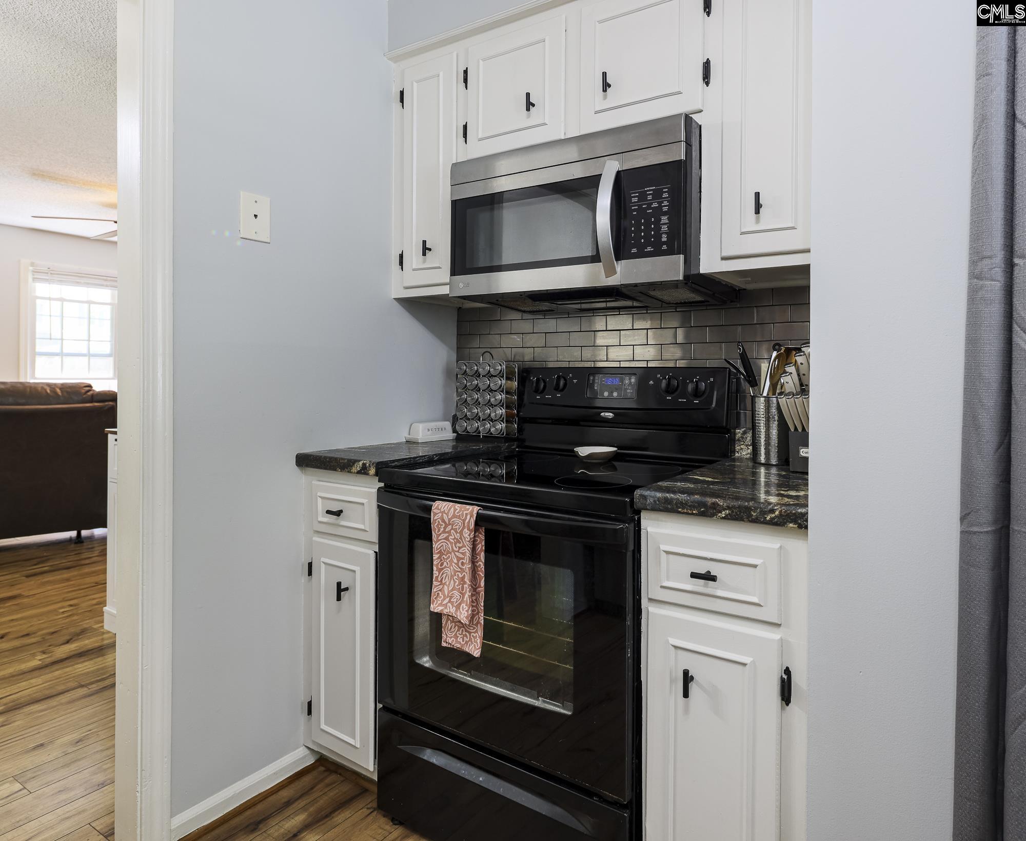 152 Thames Valley Court Irmo, SC 29063 - Photo 16 of 32 a kitchen with stainless steel appliances granite countertop a stove microwave and oven