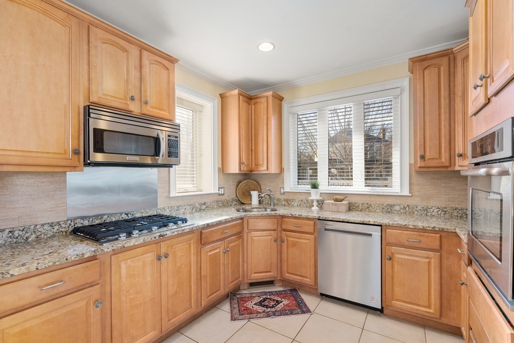 59 Elm Street Hingham, MA 02043 - Photo 11 of 33 a kitchen with granite countertop cabinets stainless steel appliances a sink and a window