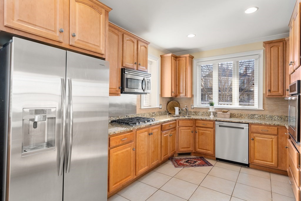 59 Elm Street Hingham, MA 02043 - Photo 12 of 33 a kitchen with stainless steel appliances granite countertop a sink and cabinets