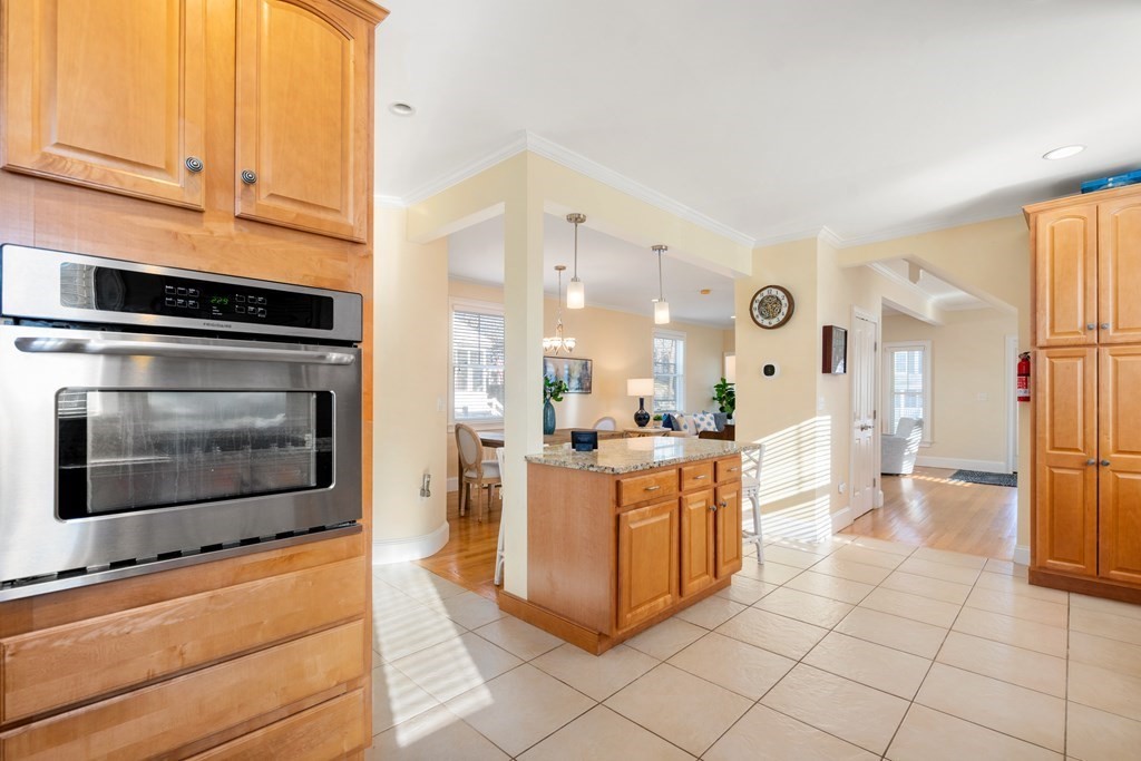 59 Elm Street Hingham, MA 02043 - Photo 13 of 33 a kitchen with stainless steel appliances kitchen island granite countertop a stove a sink and a refrigerator