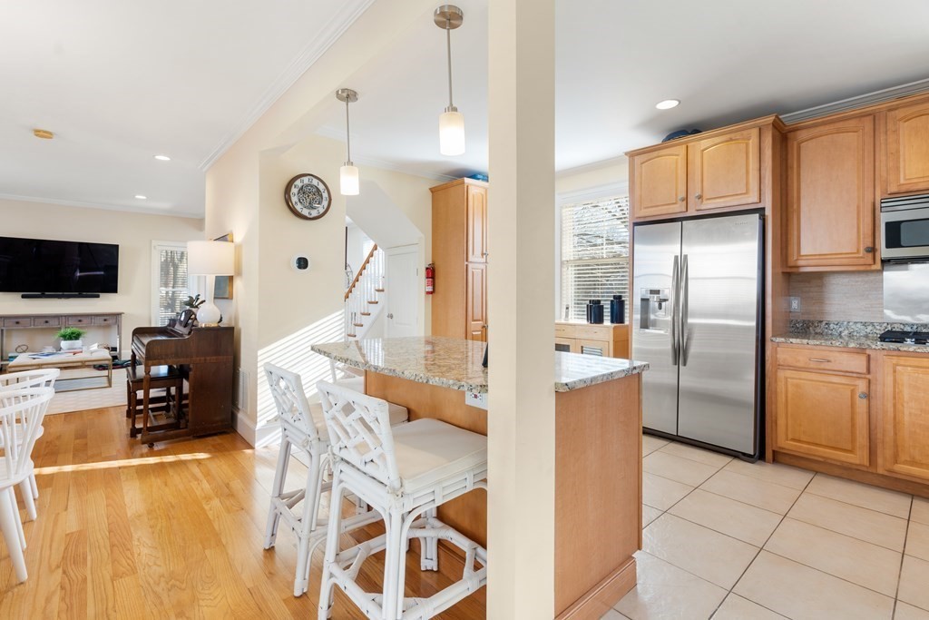 59 Elm Street Hingham, MA 02043 - Photo 14 of 33 a kitchen with stainless steel appliances granite countertop a refrigerator a stove and a sink with cabinets