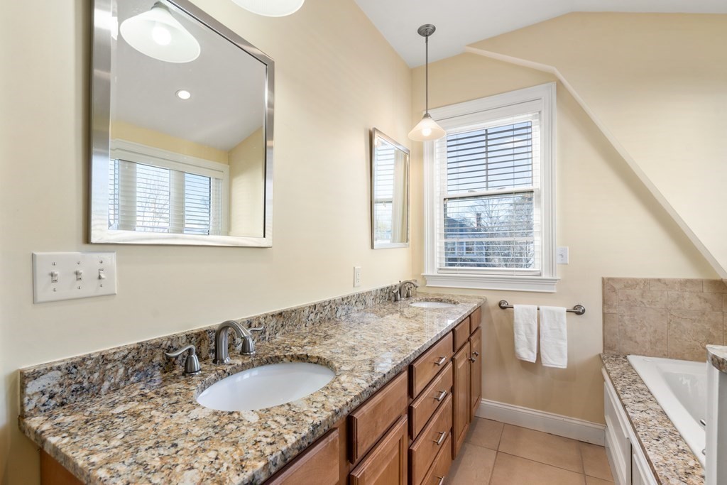 59 Elm Street Hingham, MA 02043 - Photo 26 of 33 a bathroom with a granite countertop sink and a mirror