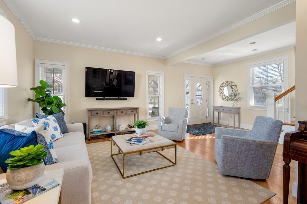 59 Elm Street Hingham, MA 02043 - Photo 5 of 33 a living room with furniture a flat screen tv and a large window