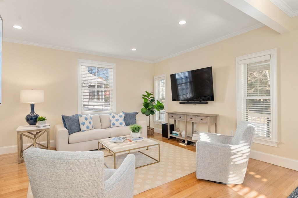 59 Elm Street Hingham, MA 02043 - Photo 6 of 33 a living room with furniture a flat screen tv and a window