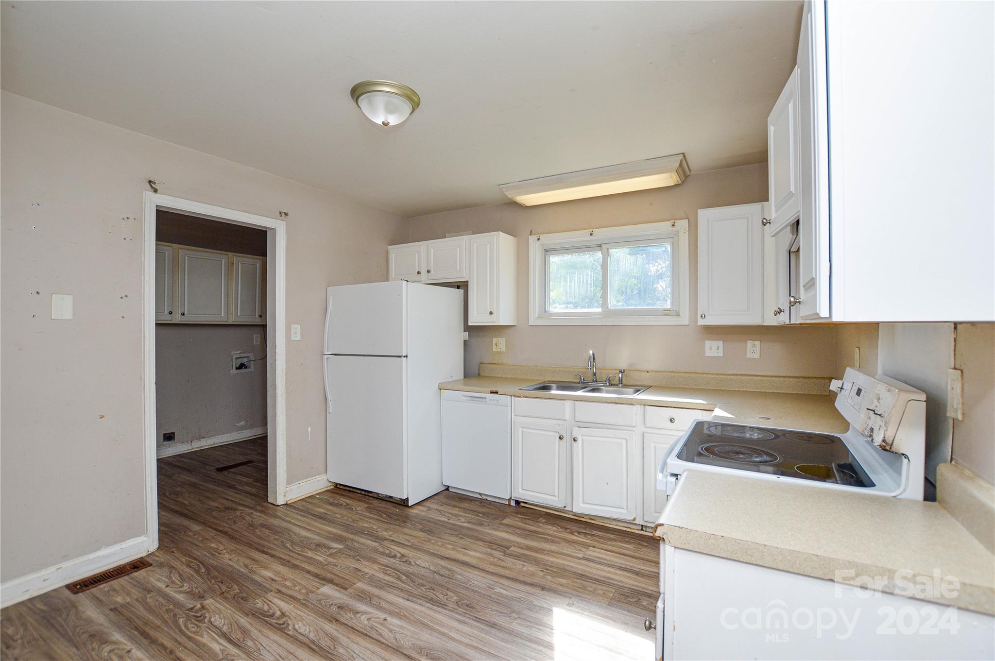 1138 White Plains Road Charlotte, NC 28213 - Photo 13 of 36 a kitchen with a refrigerator sink and cabinets