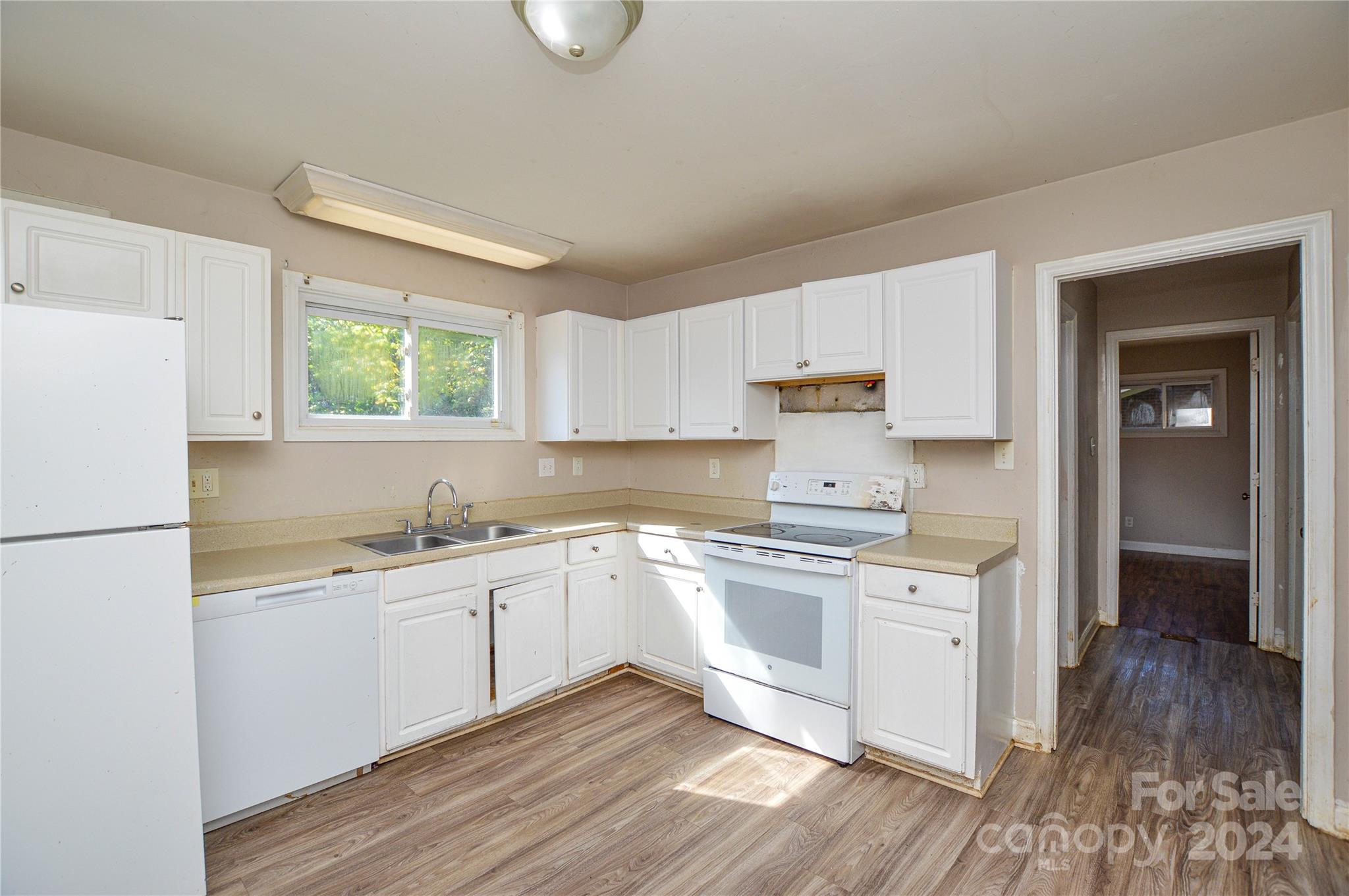 1138 White Plains Road Charlotte, NC 28213 - Photo 14 of 36 a kitchen with a sink a window and stainless steel appliances