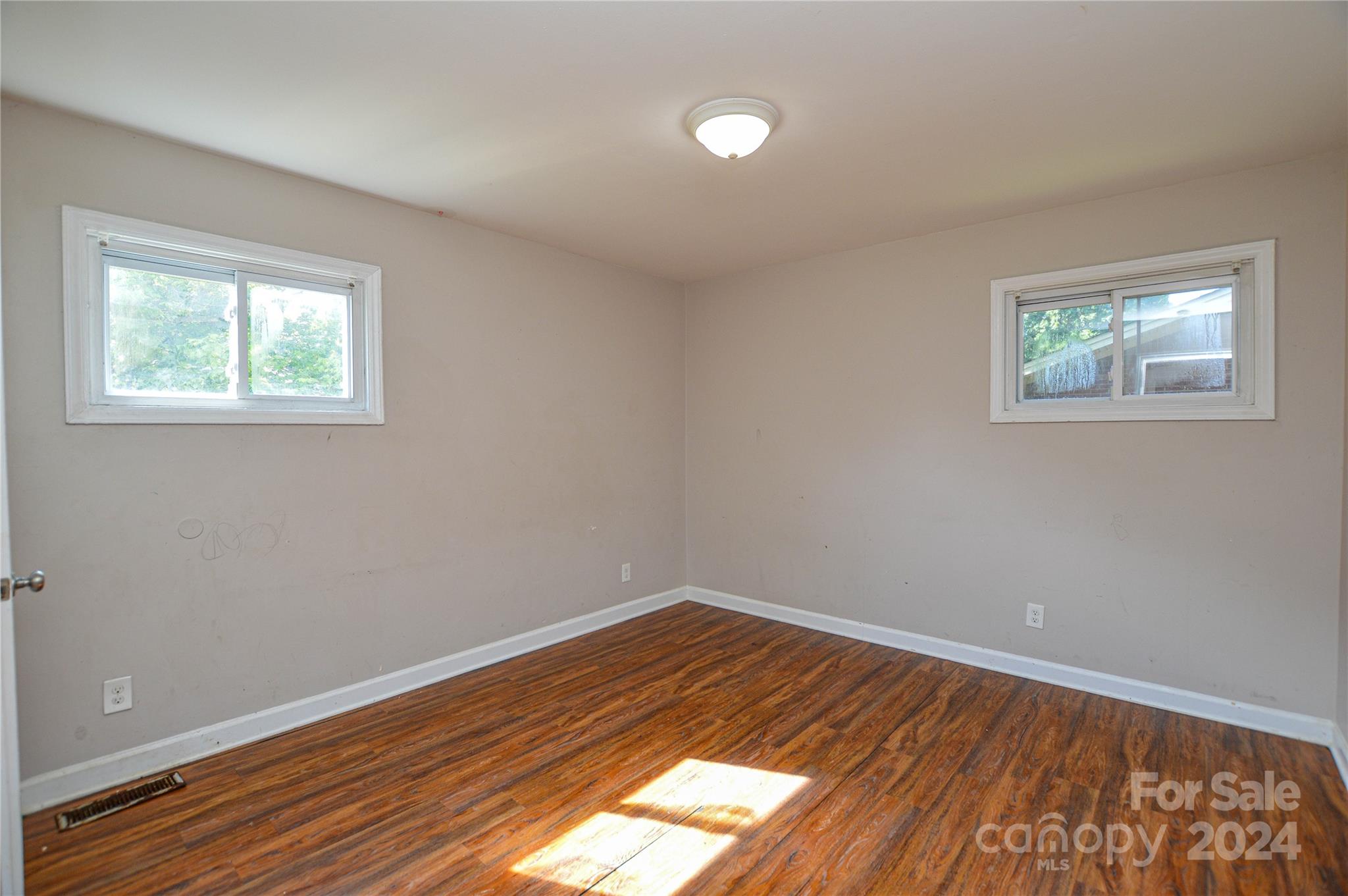 1138 White Plains Road Charlotte, NC 28213 - Photo 16 of 36 an empty room with wooden floor and windows