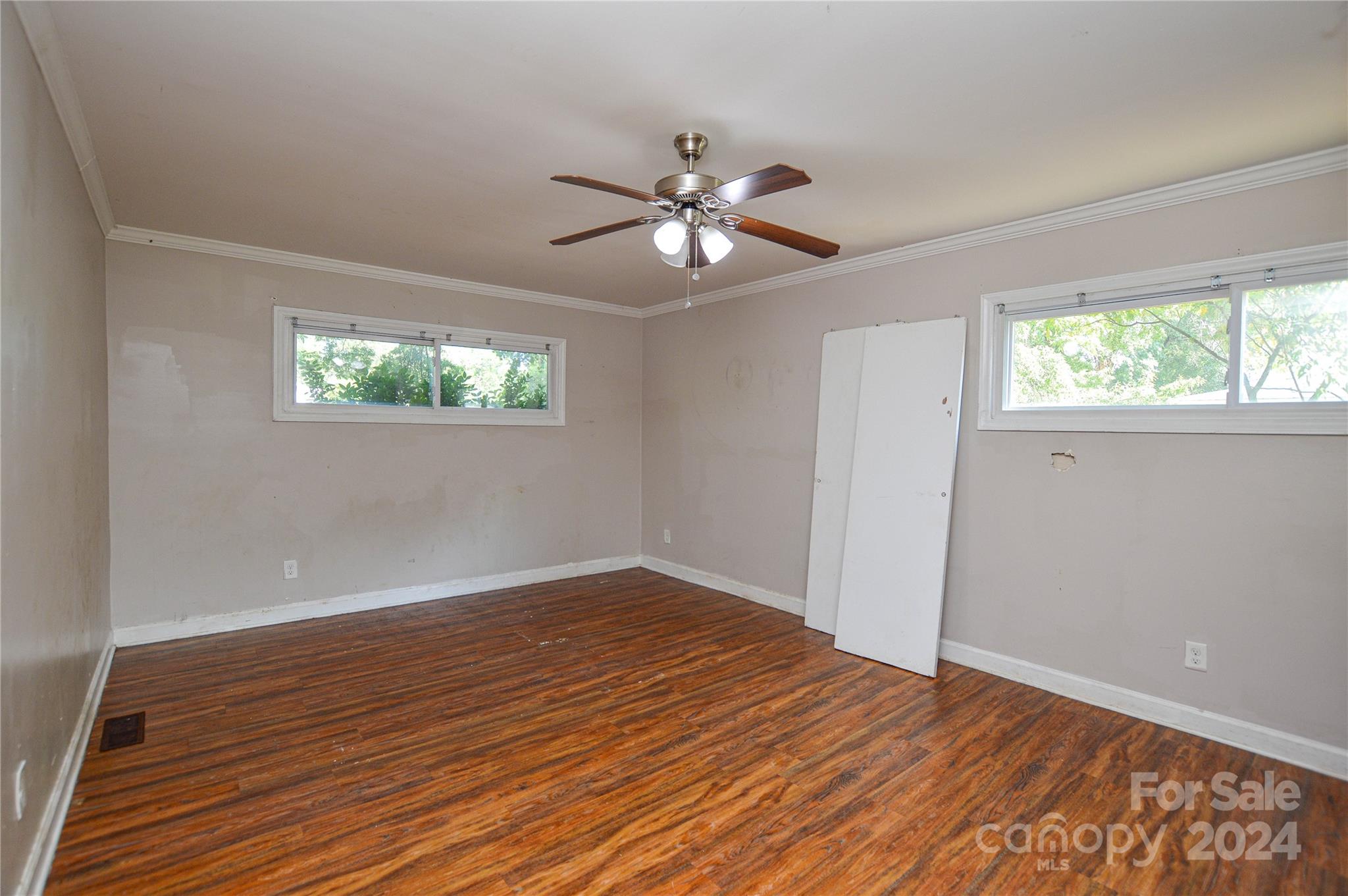 1138 White Plains Road Charlotte, NC 28213 - Photo 18 of 36 a view of empty room with wooden floor and fan