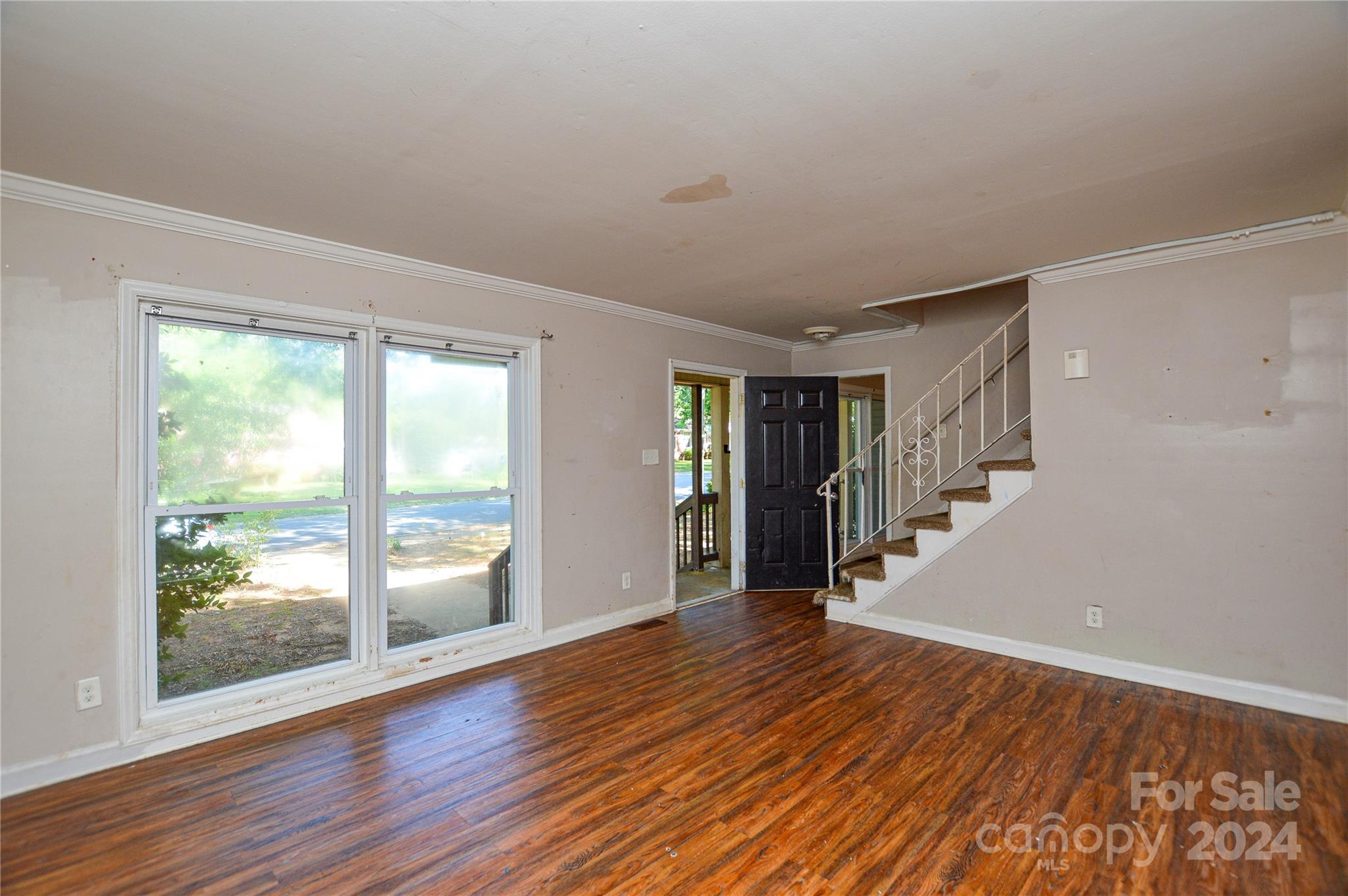 1138 White Plains Road Charlotte, NC 28213 - Photo 7 of 36 a view of an empty room with wooden floor and a window