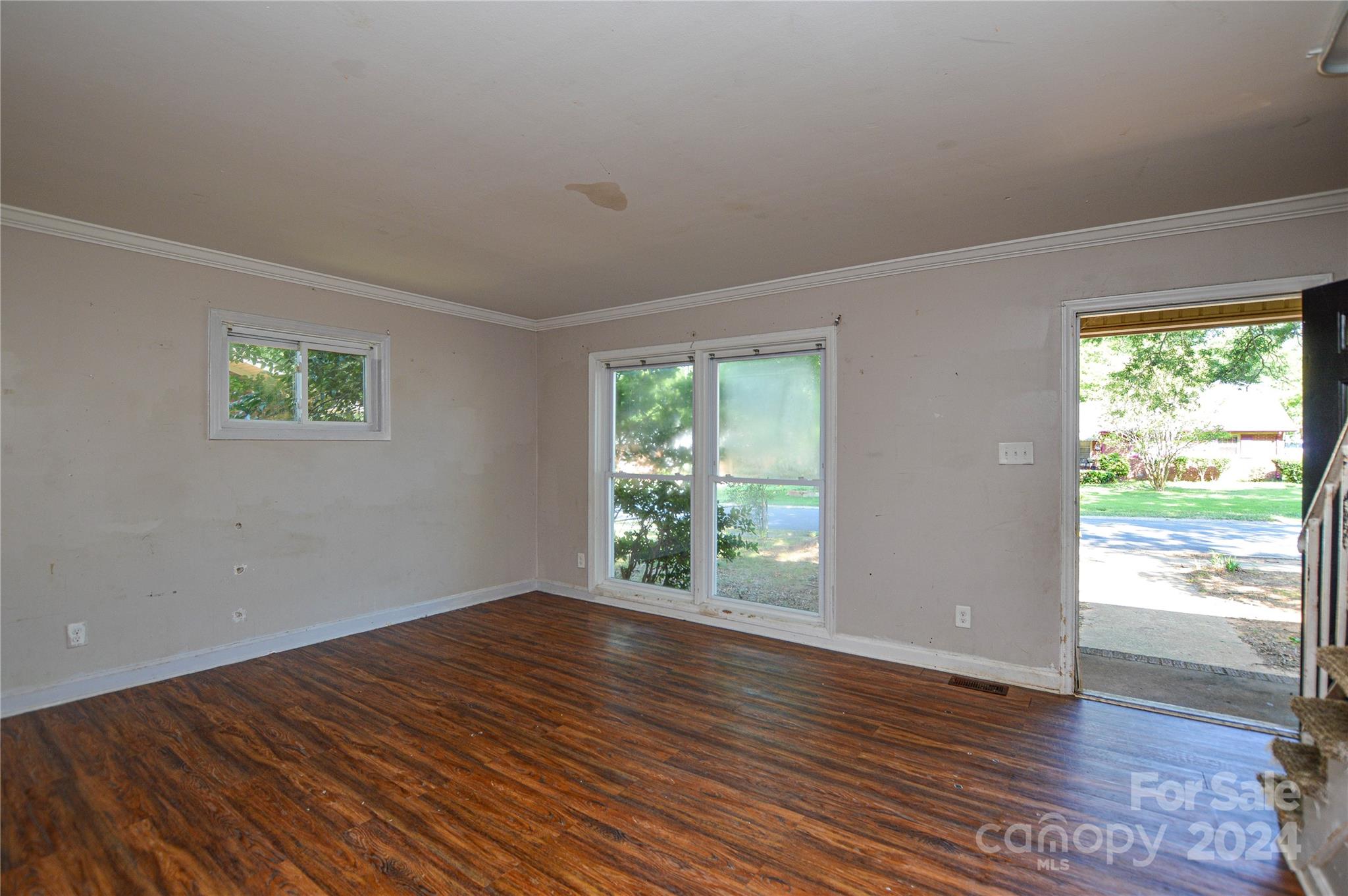 1138 White Plains Road Charlotte, NC 28213 - Photo 9 of 36 a view of an empty room with wooden floor and a window
