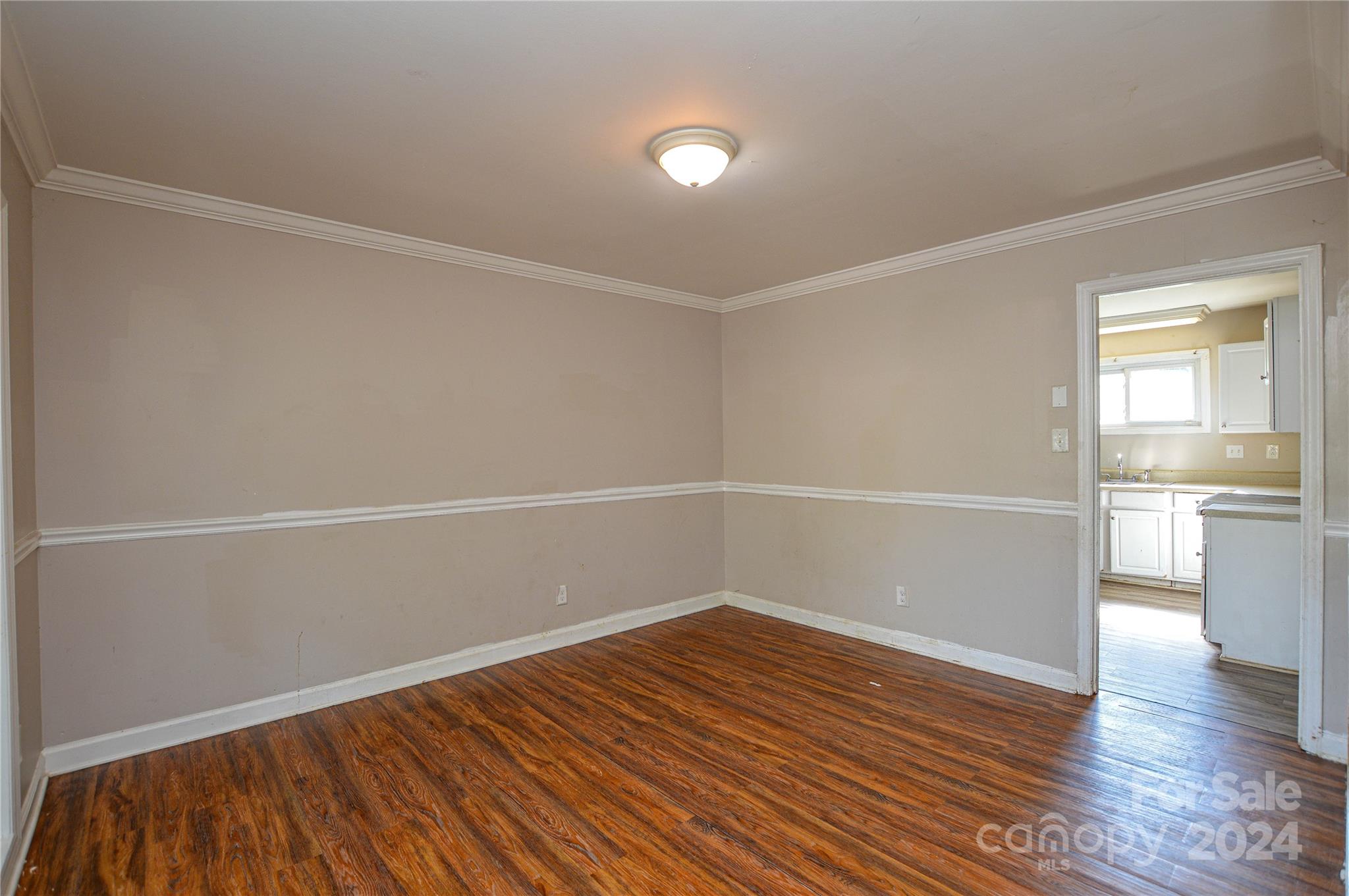 1138 White Plains Road Charlotte, NC 28213 - Photo 10 of 36 a view of a room with wooden floor and white walls