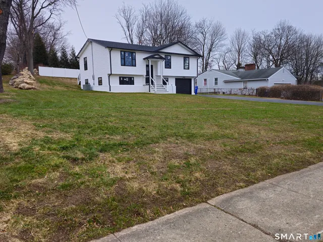 a view of a yard with a house in the background