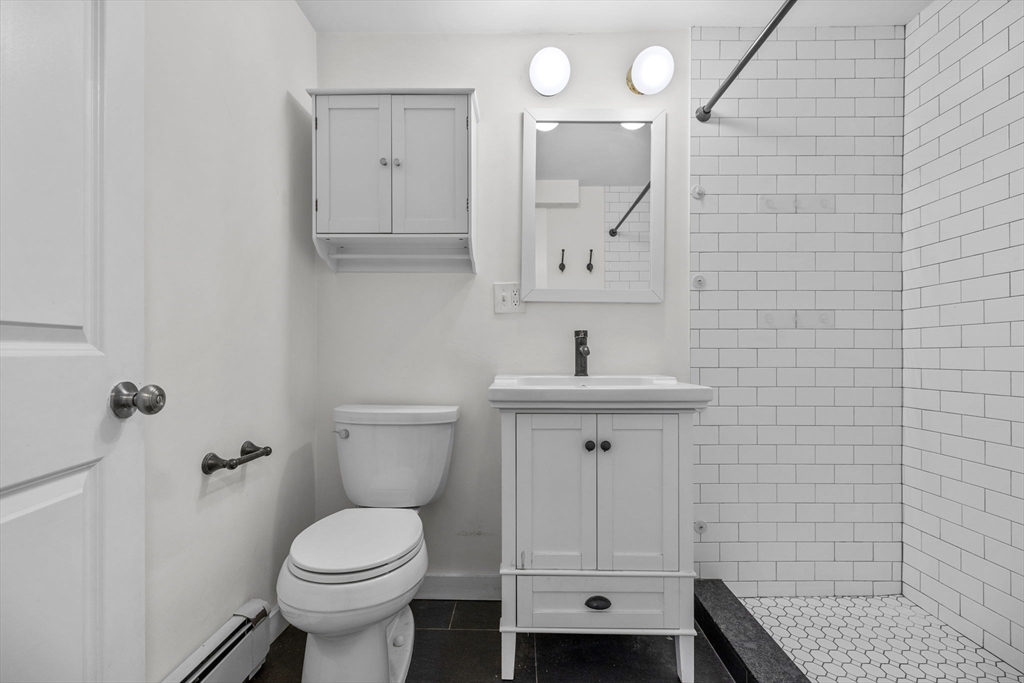 300 Marginal Street, Unit 3 Boston, MA 02128 - Photo 13 of 19 a bathroom with a toilet sink and mirror