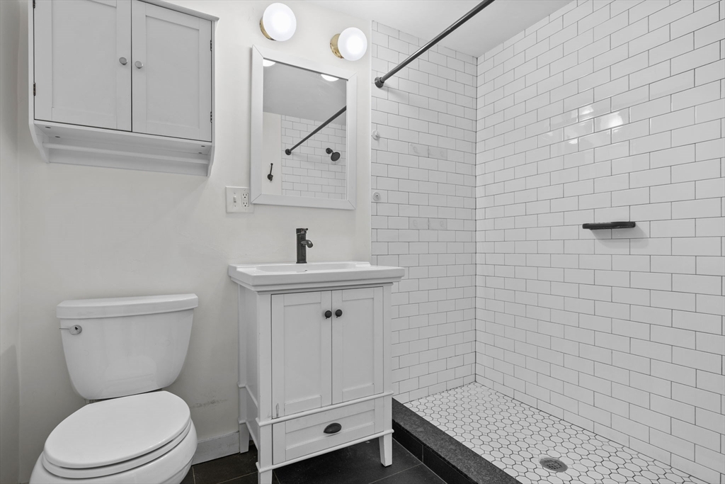 300 Marginal Street, Unit 3 Boston, MA 02128 - Photo 14 of 19 a bathroom with a toilet a sink and mirror