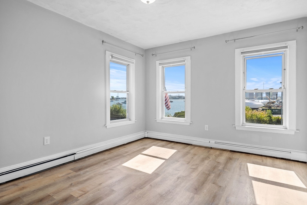 300 Marginal Street, Unit 3 Boston, MA 02128 - Photo 2 of 19 wooden floor in an empty room with a window
